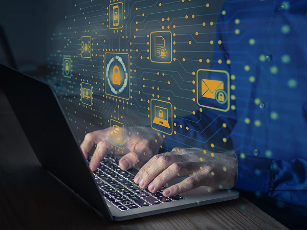 A person types on a laptop keyboard with digital security icons and a network background overlay.