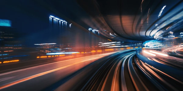 Light trails in a night cityscape, motion on tracks